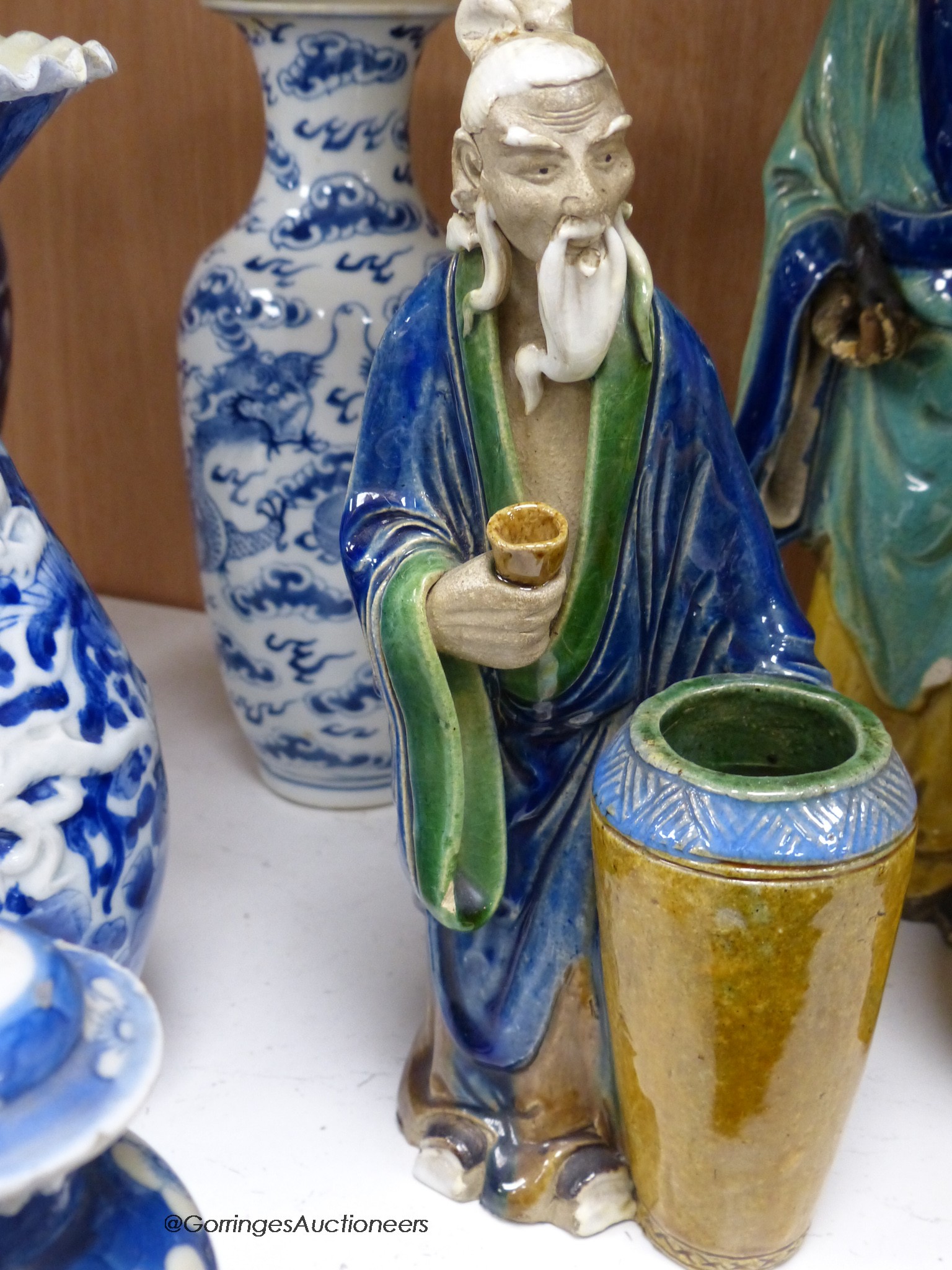 A collection of Chinese vases pottery figures and a compressed tea block, tallest piece 35cm